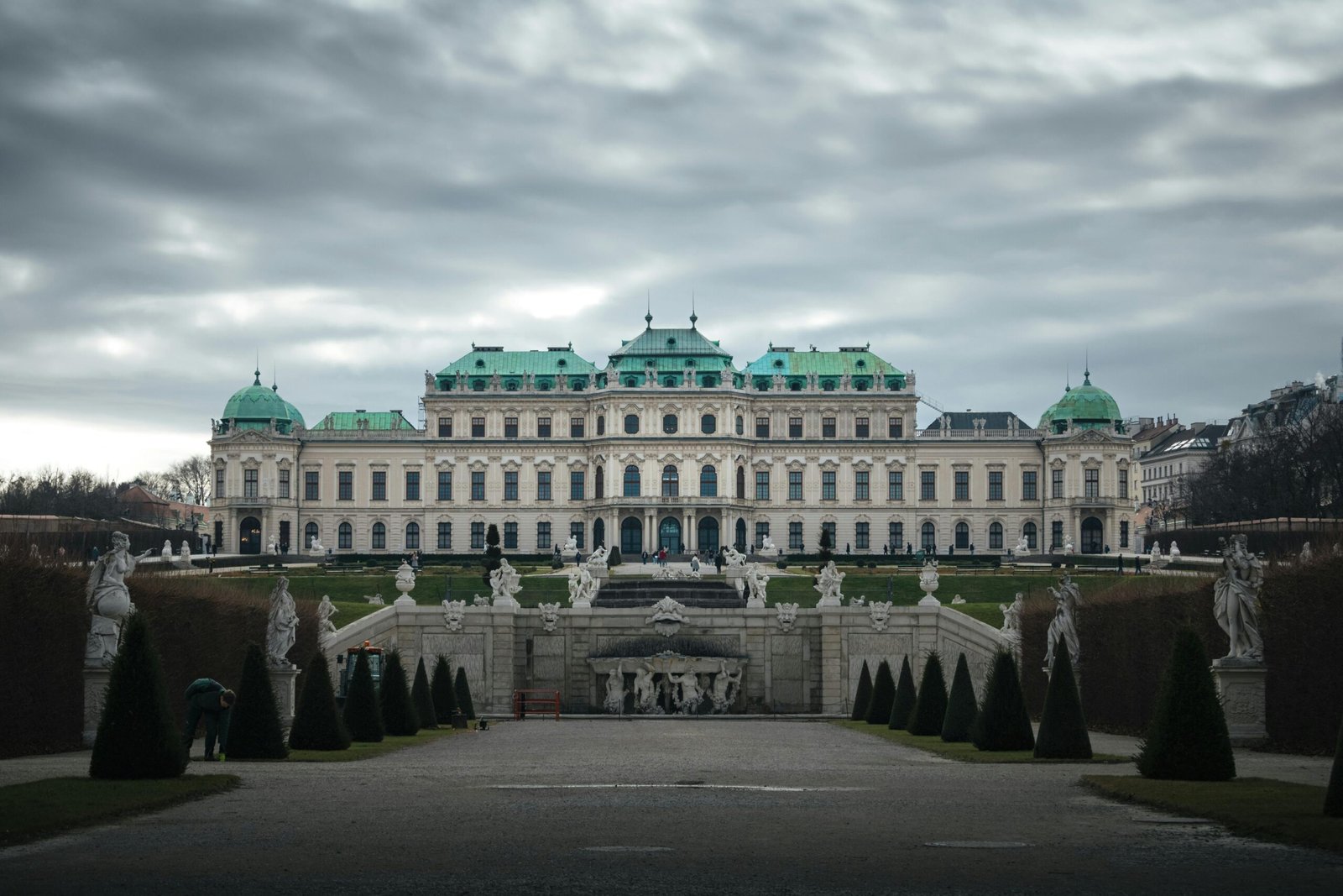 A front view of Belvedere Palace in Vienna, Austria against a moody sky.