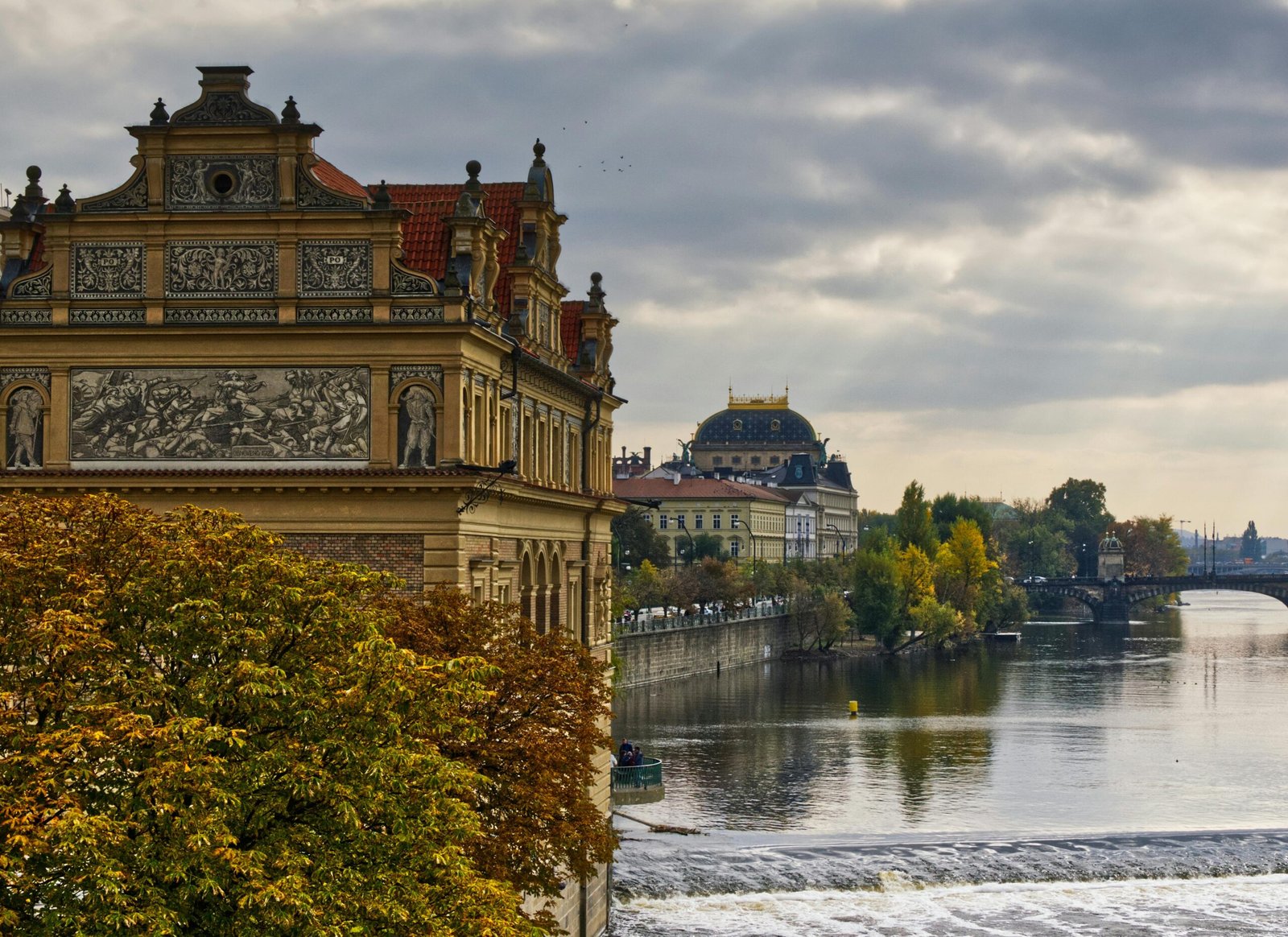 Beautiful autumn scene showcasing historic architecture along a river in Vienna, Austria.