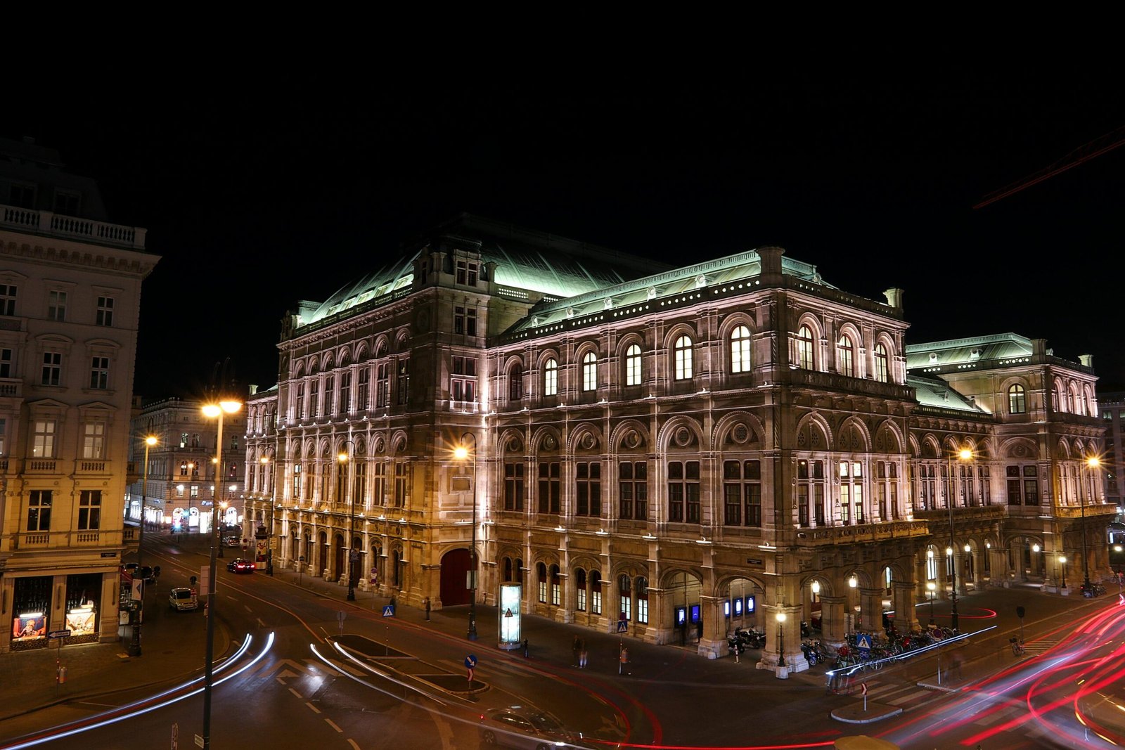Illuminated Vienna State Opera at night, showcasing famous architectural grandeur in Austria.
